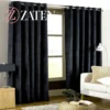 Pair of premium midnight black velvet curtains with silver eyelets, showing a deep, light-absorbing plush fabric for maximum privacy.